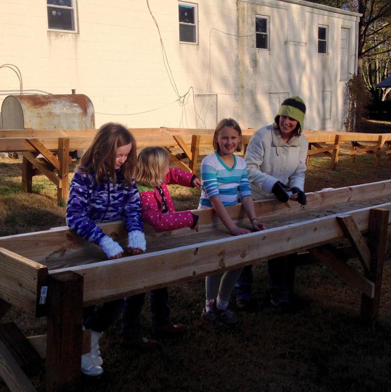Children sifting through a water stream