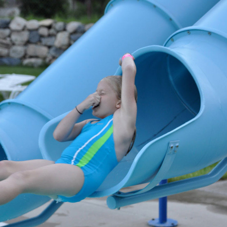 Girl going down a water slide.
